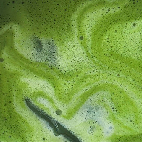 matcha tea inspired matcha tea foam with vibrant green swirls and bubbles.